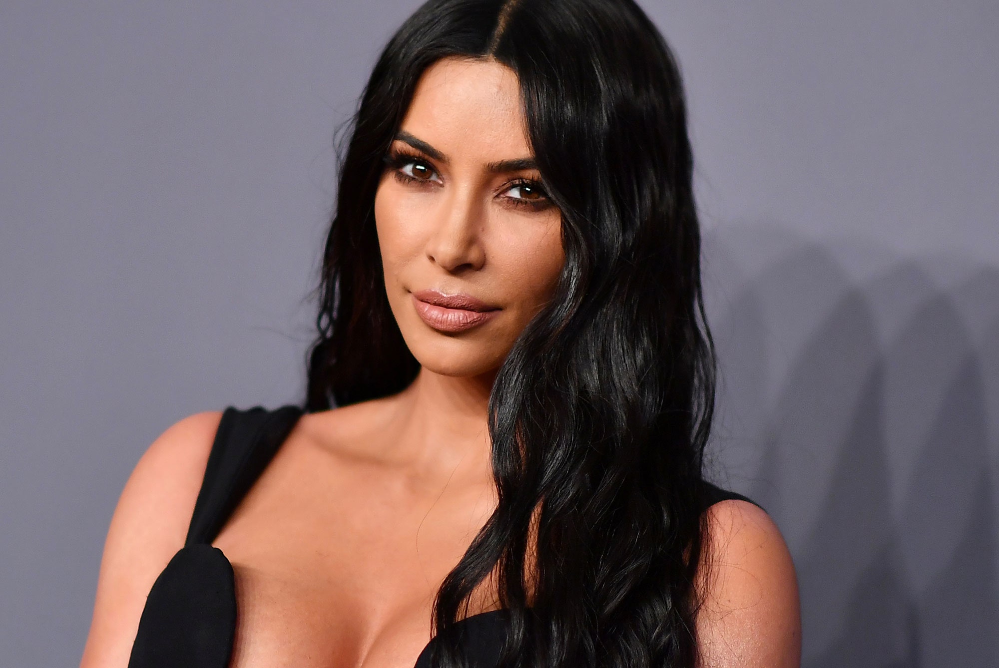 Kim Kardashian Lazes in Skintight Bodysuit and Jeans